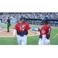 Toledo Mud Hens react after scoring a run