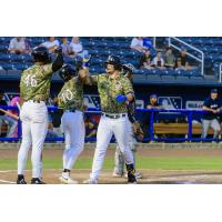 Biloxi Shuckers' Brock Wilken congratulated by teammates