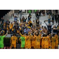 Rhode Island FC celebrates in front of its supporters