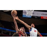 Craig Porter, Jr. of the Canton Charge (left) attempts a layup against the Motor City Cruise